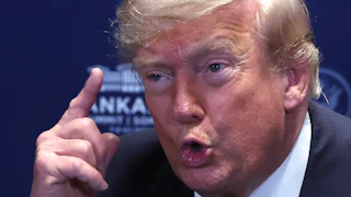 Donald Trump holds up a finger while speaking