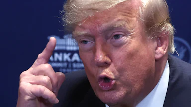Donald Trump holds up a finger while speaking
