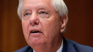 Senator Lindsey Graham looks up.