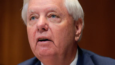 Senator Lindsey Graham looks up.