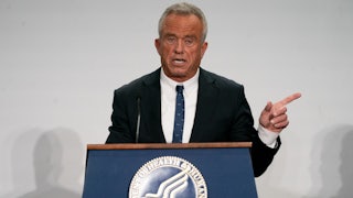Robert F. Kennedy Jr. points to the side while speaking at a podium