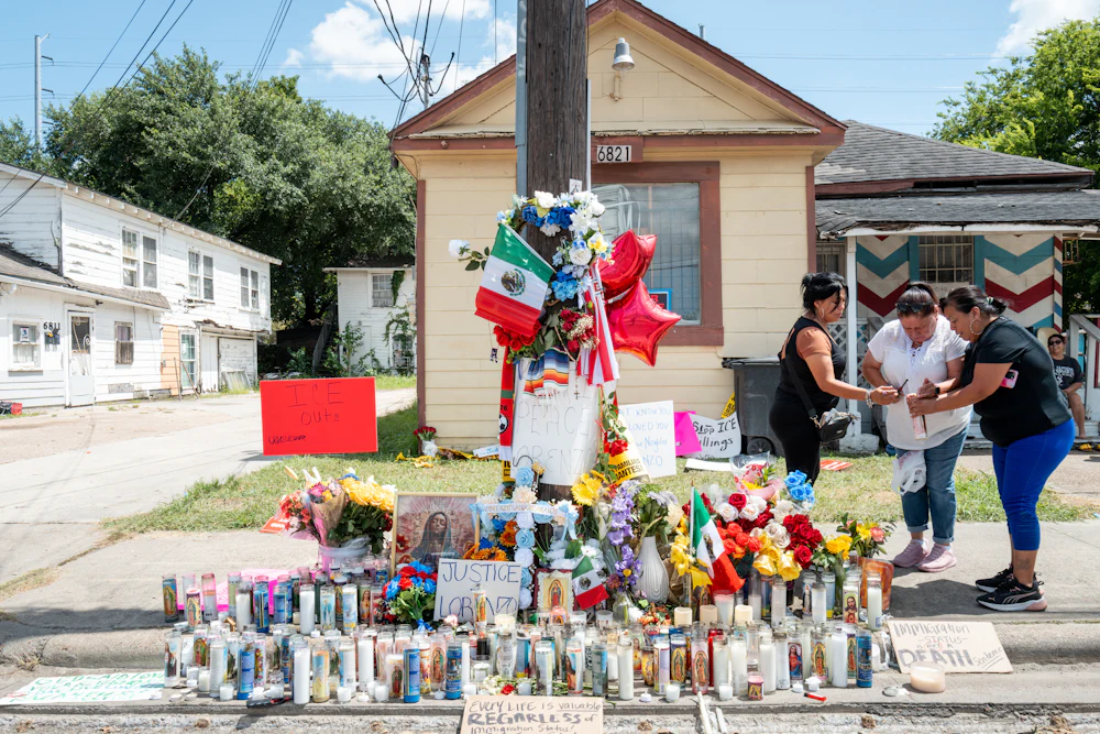 People paid their respects at the site, covered in candles and flowers, where ICE agents shot and killed Lorenzo Salgado Araujo on July 7.