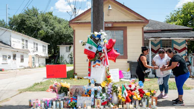 People paid their respects at the site, covered in candles and flowers, where ICE agents shot and killed Lorenzo Salgado Araujo on July 7.