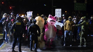 Protesters stand in front of federal officers in Portland, Oregon