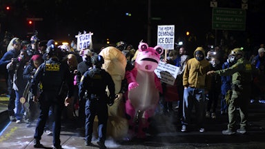 Protesters stand in front of federal officers in Portland, Oregon