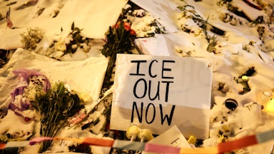 A sign at a memorial for Alex Pretti in Minneapolis, Minnesota, says, "ICE out now"
