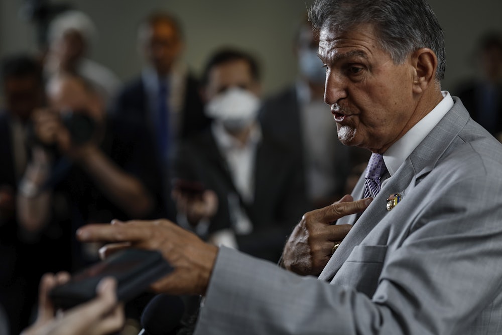 Senator Manchin gesticulates while speaking.