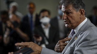 Senator Manchin gesticulates while speaking.