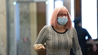 Senator Kyrsten Sinema of Arizona wears a protective mask while arriving at the Capitol on December 11.