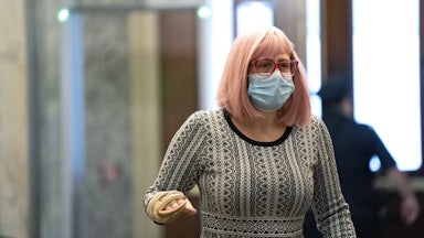 Senator Kyrsten Sinema of Arizona wears a protective mask while arriving at the Capitol on December 11.