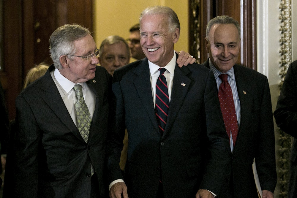 Senators Harry Reid and Chuck Schumer leave the Senate chamber with a beaming Vice President Biden in 2012