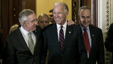 Senators Harry Reid and Chuck Schumer leave the Senate chamber with a beaming Vice President Biden in 2012