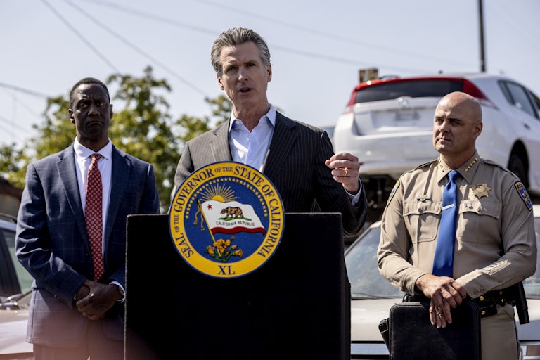 Gavin Newsom speaks at a podium during a press conference