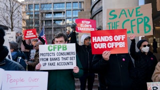 Protesters hold up signs reading "Hands Off Our CFPB," "Save the CFPB," and "CFPB Protects Consumers From Banks That Set Up Fake Accounts."