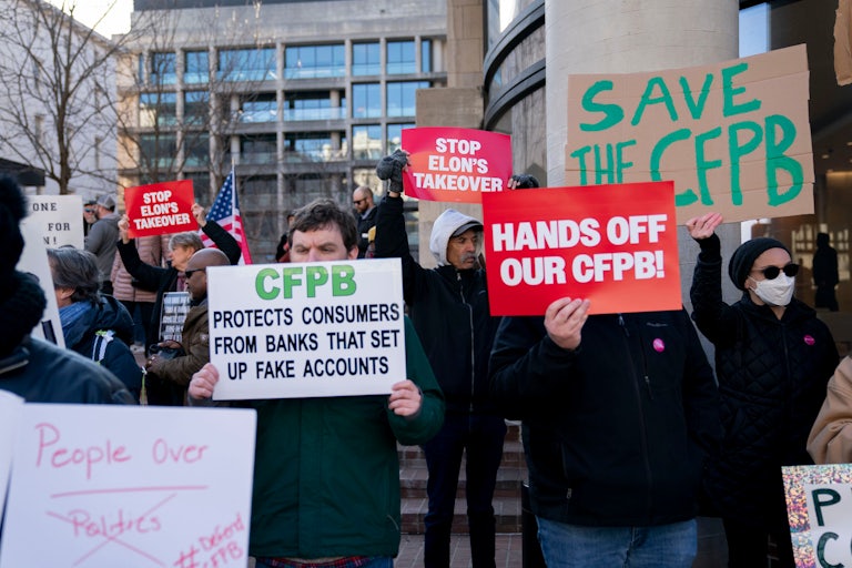 Protesters hold up signs reading "Hands Off Our CFPB," "Save the CFPB," and "CFPB Protects Consumers From Banks That Set Up Fake Accounts."