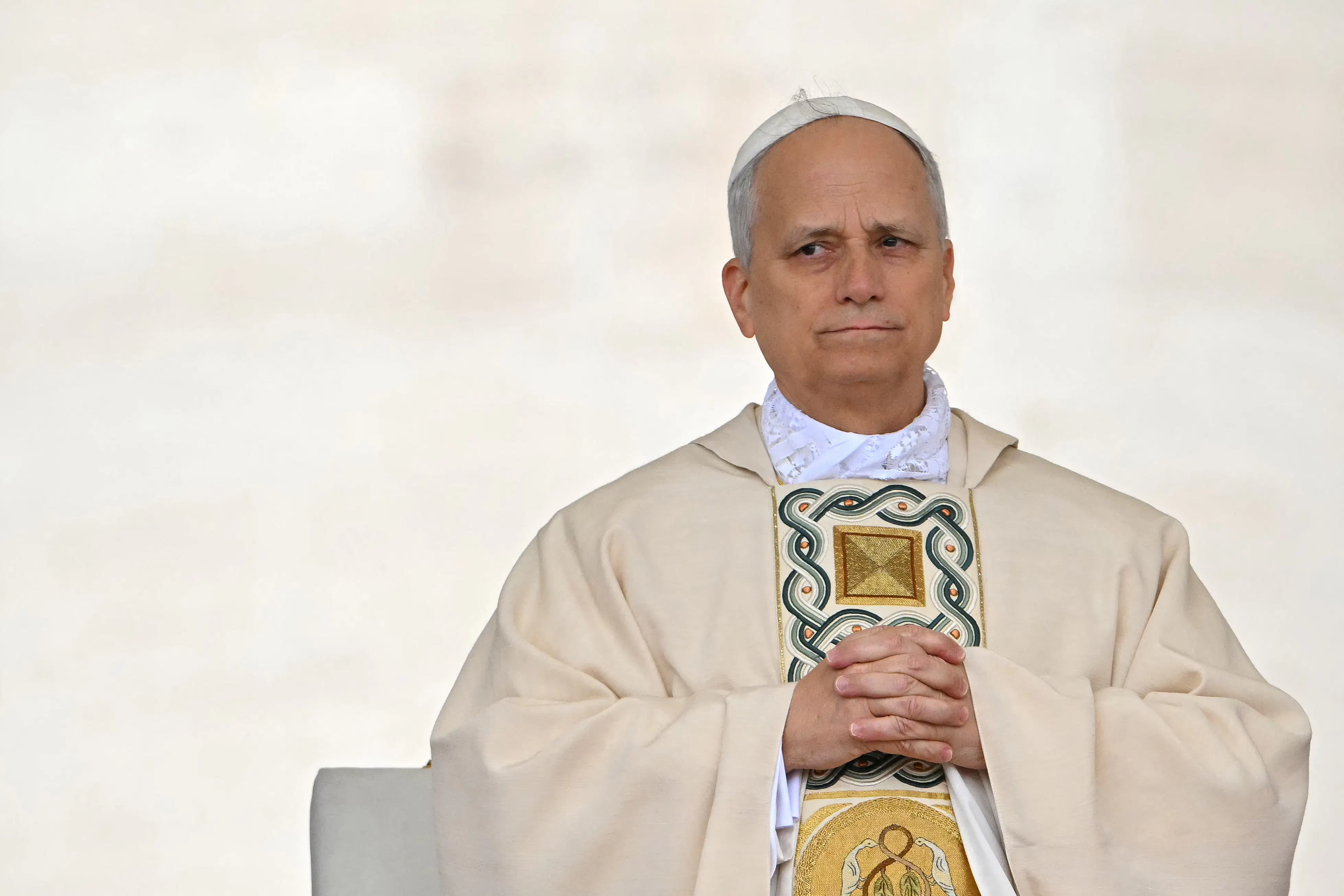 Pope Leo XIV clasps his hands together