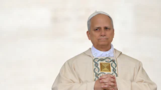 Pope Leo XIV clasps his hands together