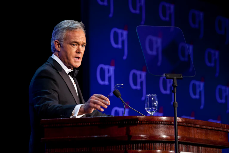 Scott Pelley stands at a podium on stage while speaking at the Committee to Protect Journalists’ 2013 International Press Freedom Awards.