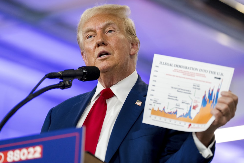 Donald Trump speaks while holding a document about illegal immigration during a visit to the Livingston County Sheriff's Office in Howell, Michigan.