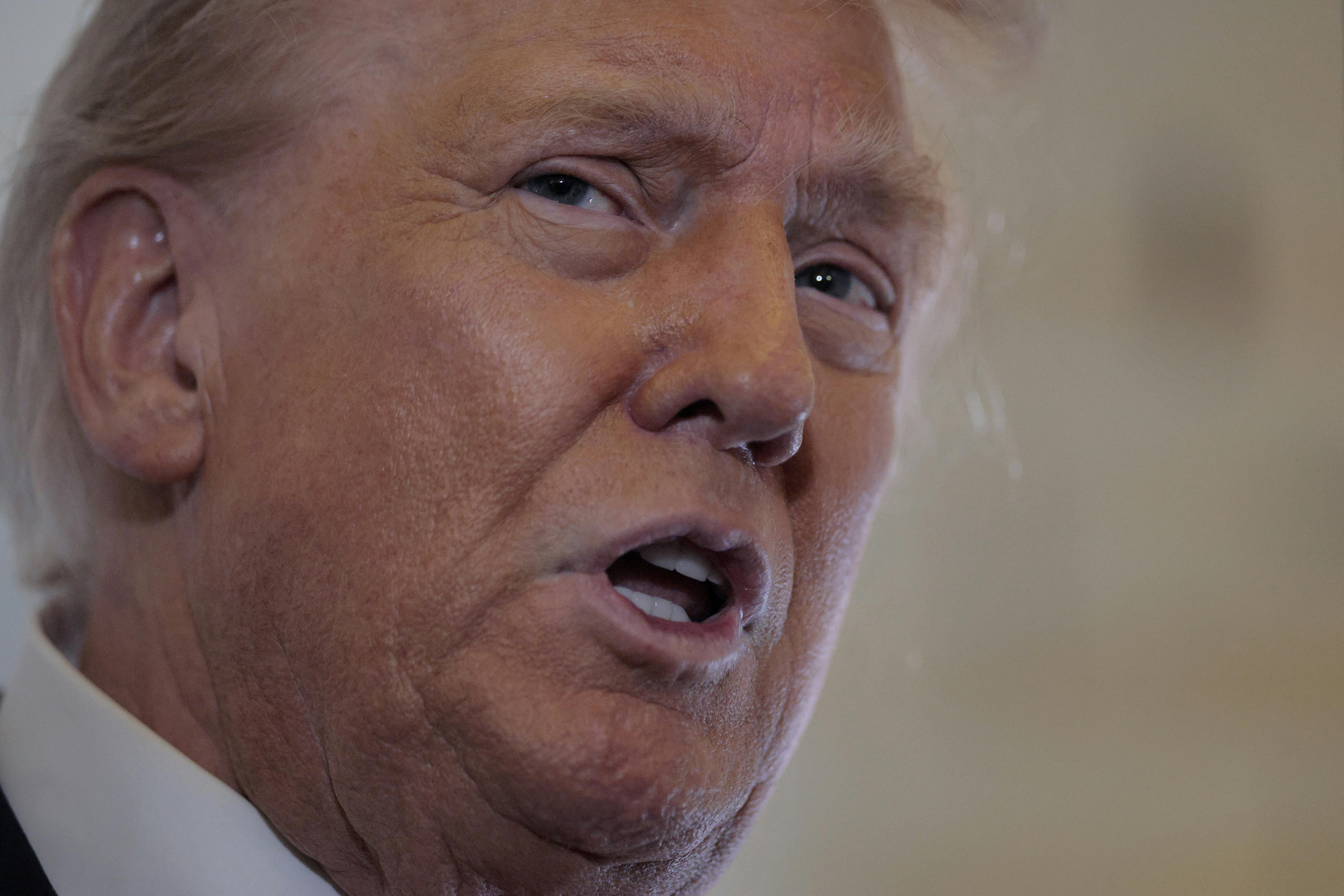 Donald Trump speaks to reporters on Air Force One