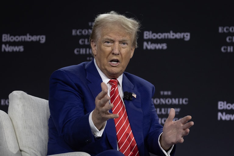 Donald Trump on stage at the Bloomberg interview talks and makes animated hand gestures