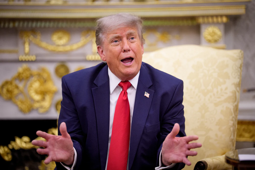 Donald Trump spreads hands, gesticulating while talking
