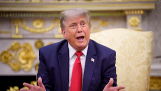 Donald Trump spreads hands, gesticulating while talking