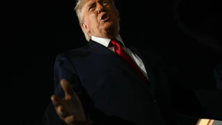 President Donald Trump speaks to reporters outside.