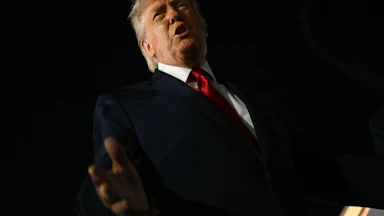 President Donald Trump speaks to reporters outside.
