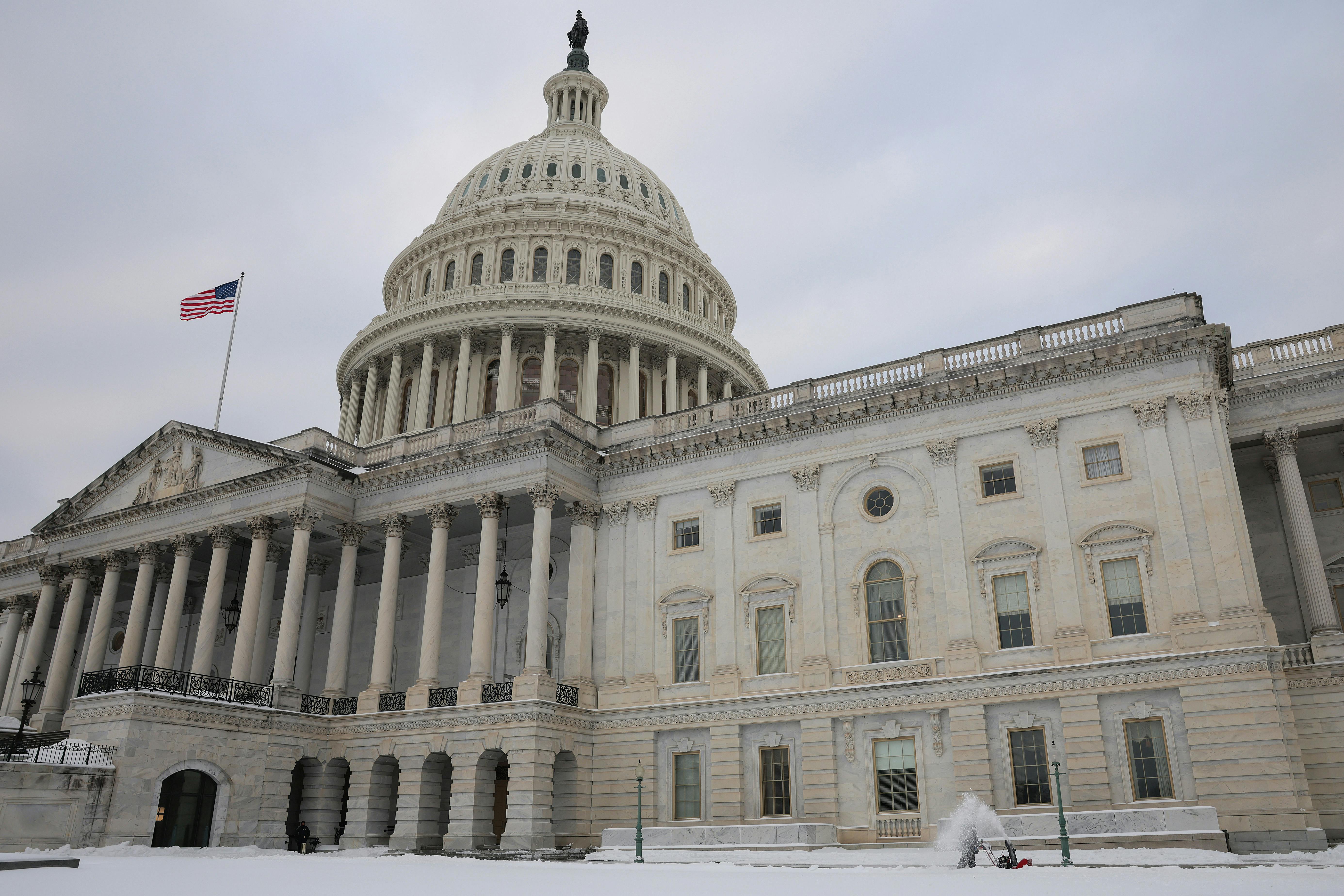 Capitol building with snow on the lawn
