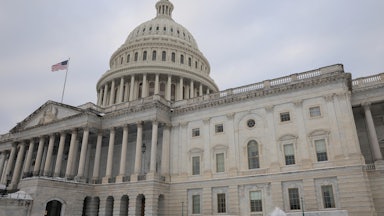 Capitol building with snow on the lawn