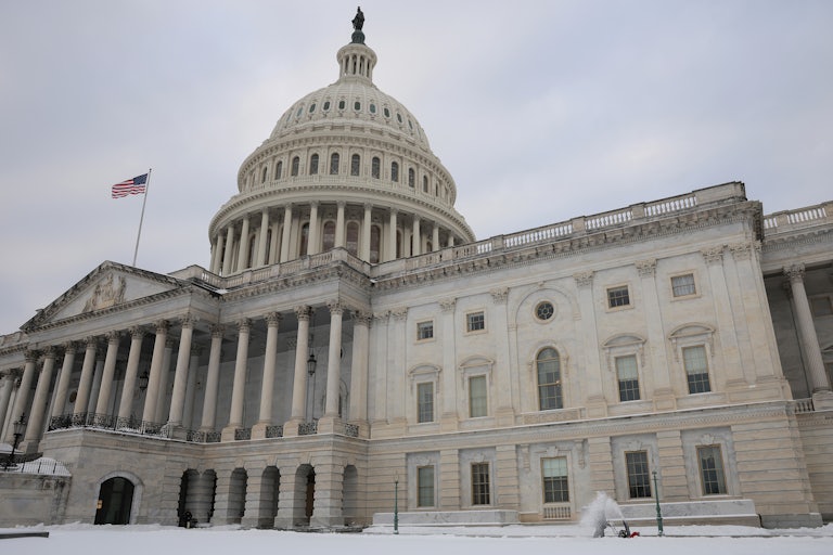 Capitol building with snow on the lawn