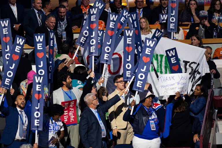 Democratic National Convention attendees attempt to hide a banner that reads, “Stop Arming Israel”