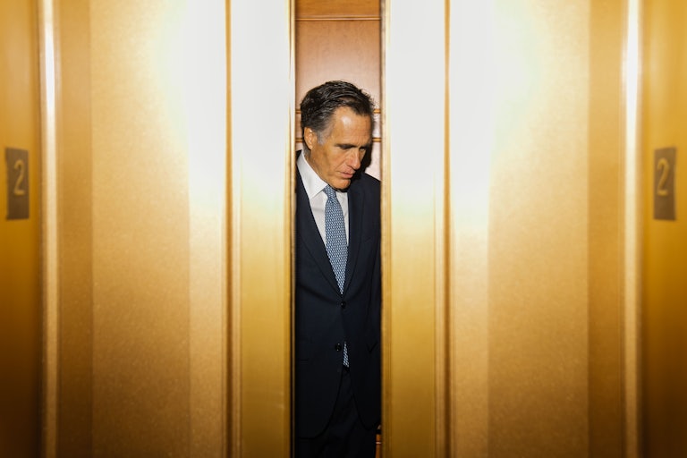 Mitt Romney departs the Senate Chamber following a vote at the U.S. Capitol.