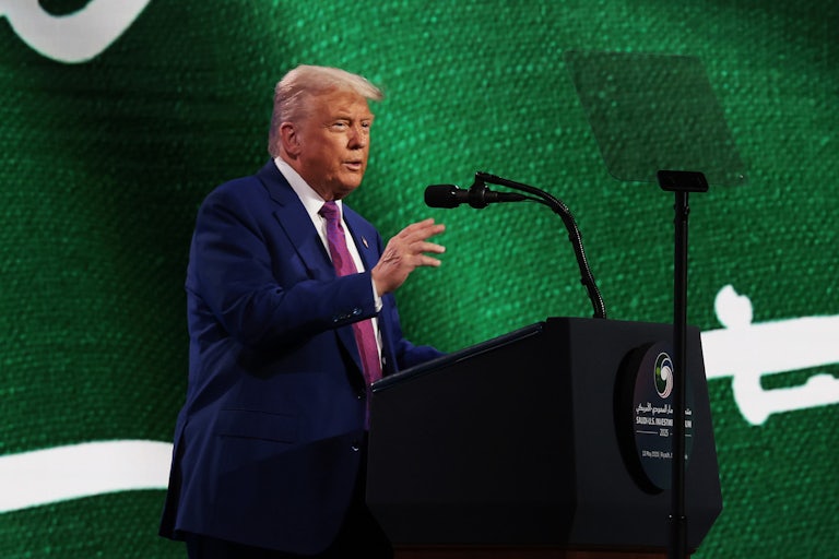Donald Trump gestures while speaking at a podium onstage in Riyadh, Saudi Arabia