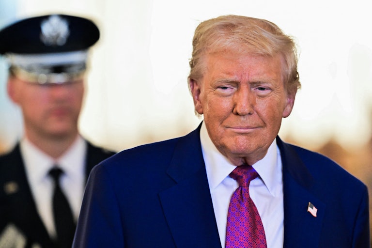 Donald Trump smiles while arriving in Abu Dhabi