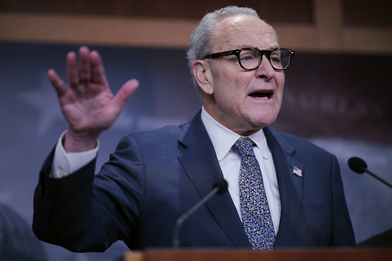 Senator Chuck Schumer gestures with one hand while speaking at a podium