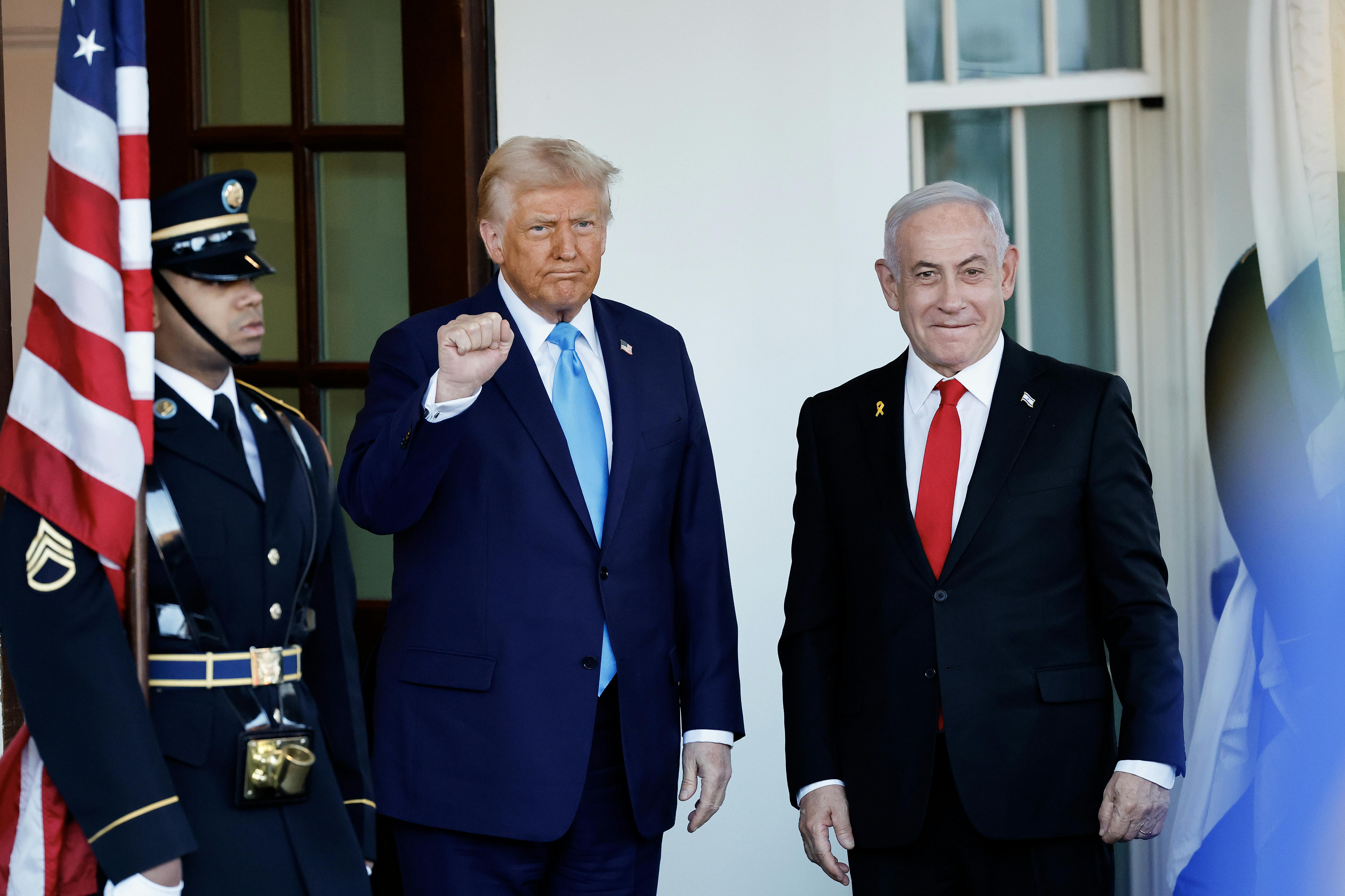 Trump holds up his fist as he stands next to Netanyahu at the White House