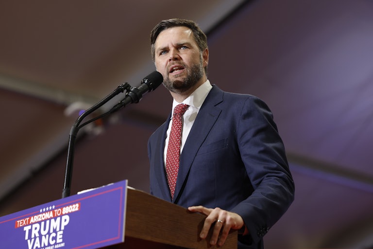 J.D. Vance speaks at a podium during a campaign rally