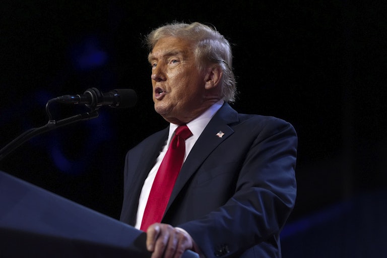 Donald Trump speaks while standing at a podium