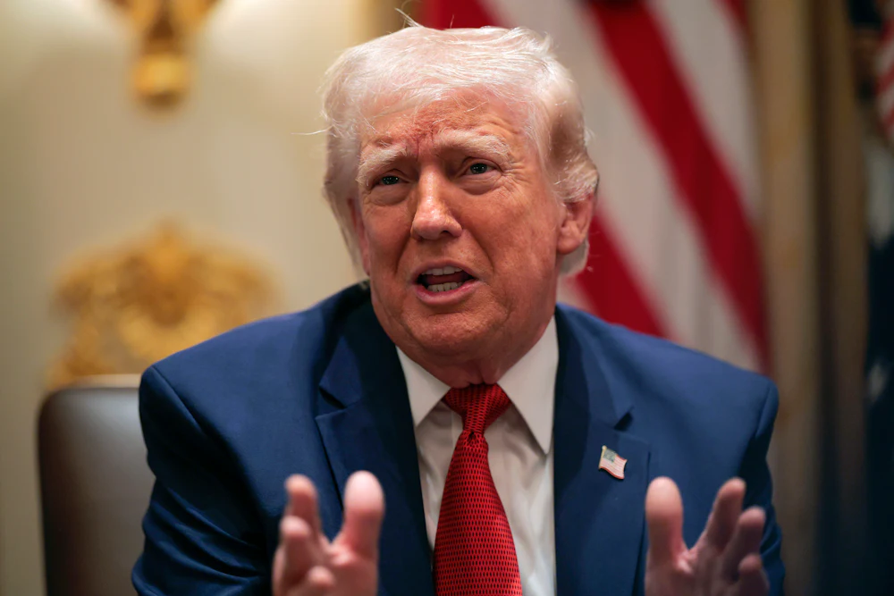 Trump holds up hands while sneering