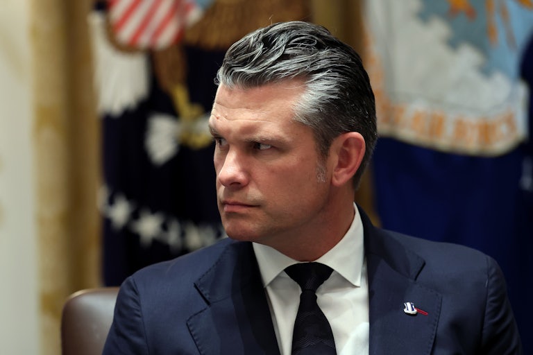 Defense Secretary Pete Hegseth looks to his right.