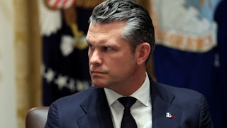 Defense Secretary Pete Hegseth looks to his right.