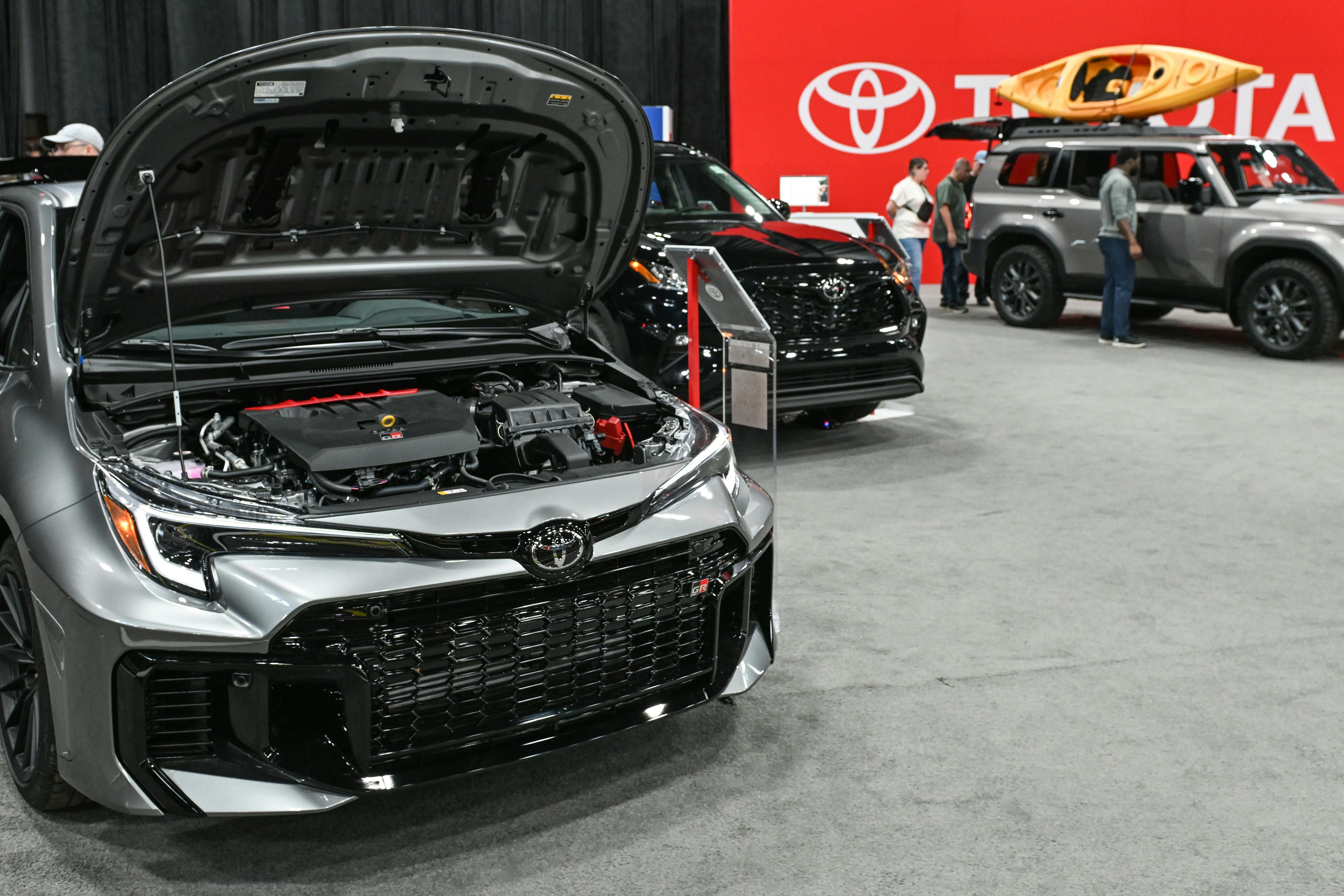2025 Toyota vehicles on display, one with its hood open, at the Edmonton Motor Show on April 13, 2025. 