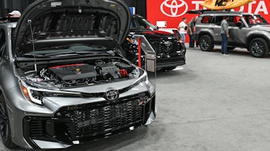 2025 Toyota vehicles on display, one with its hood open, at the Edmonton Motor Show on April 13, 2025.