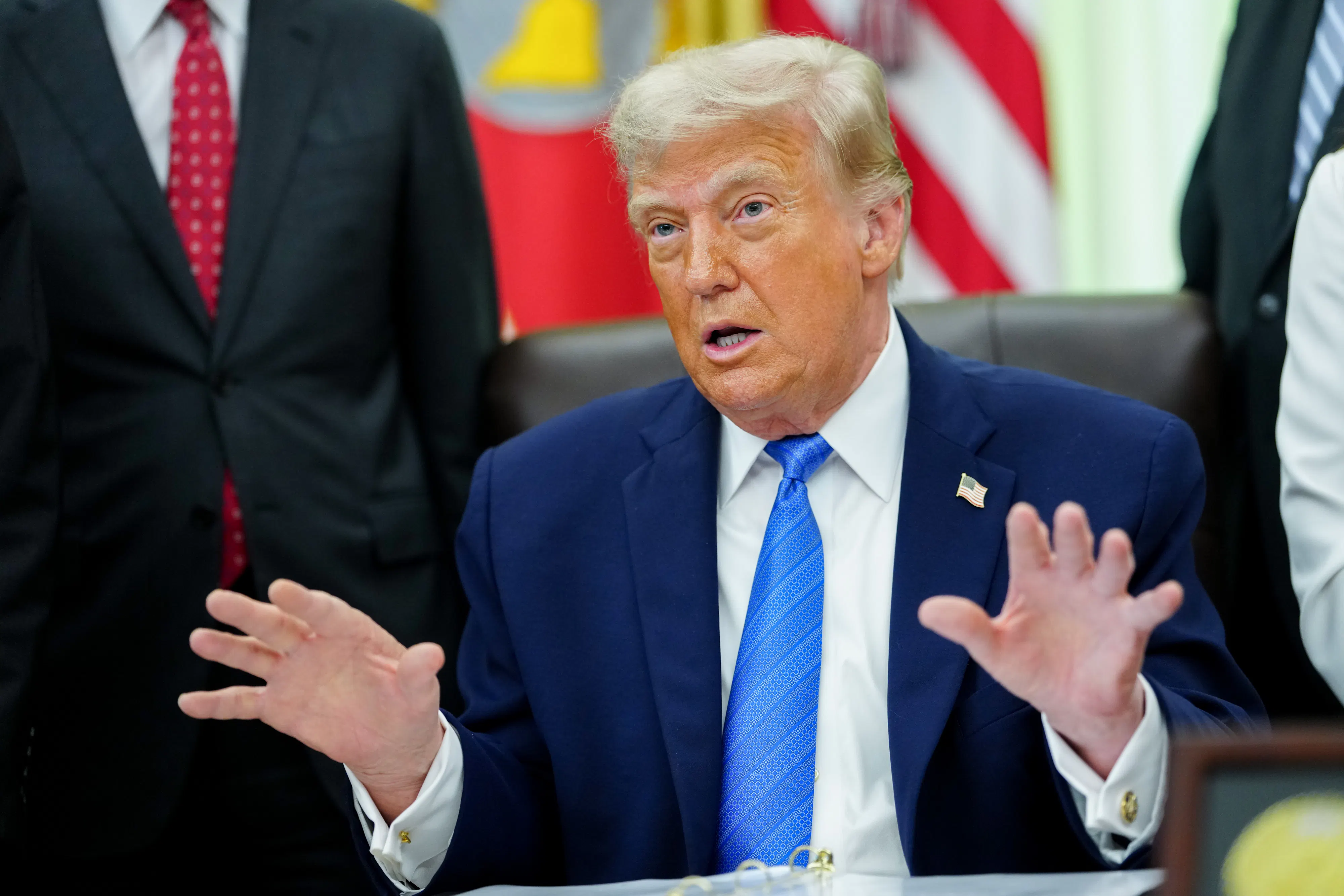 President Trump speaking at his deks in the Oval Office of the White House
