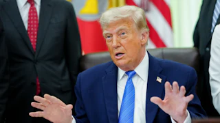 President Trump speaking at his deks in the Oval Office of the White House