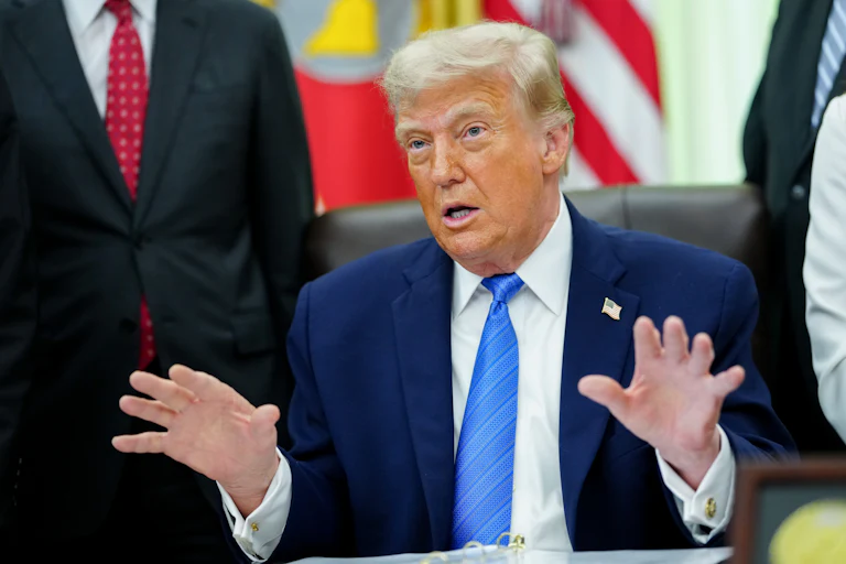 President Trump speaking at his deks in the Oval Office of the White House