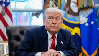 President Donald Trump sits at his desk in the Oval Office.