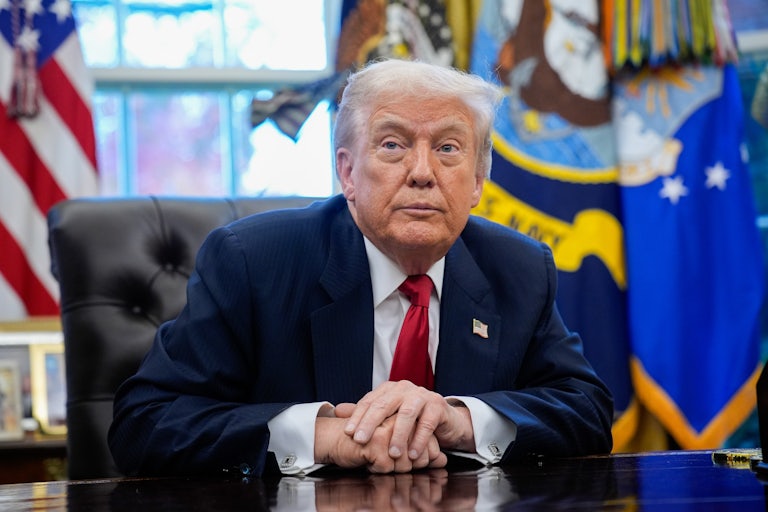 President Donald Trump sits at his desk in the Oval Office.